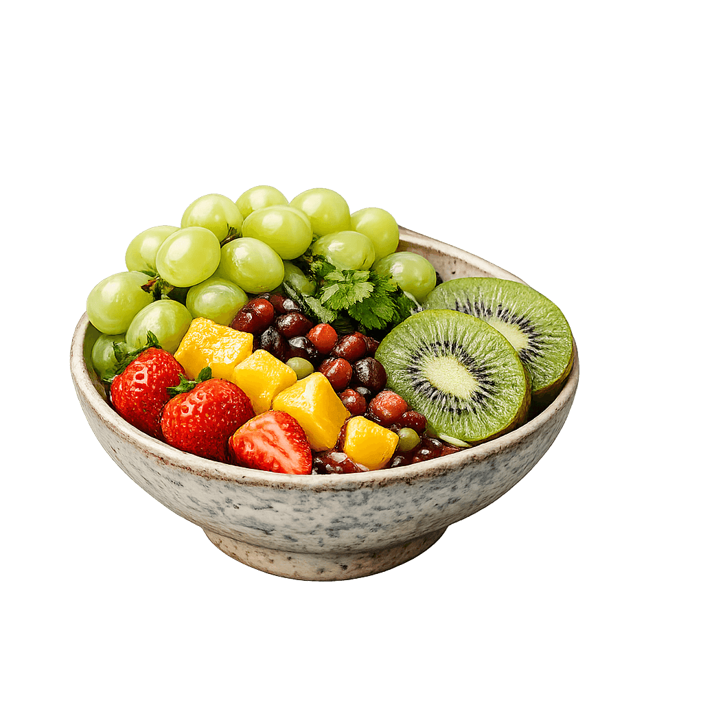 Bowl of fresh fruit with grapes, strawberries, mango and kiwi